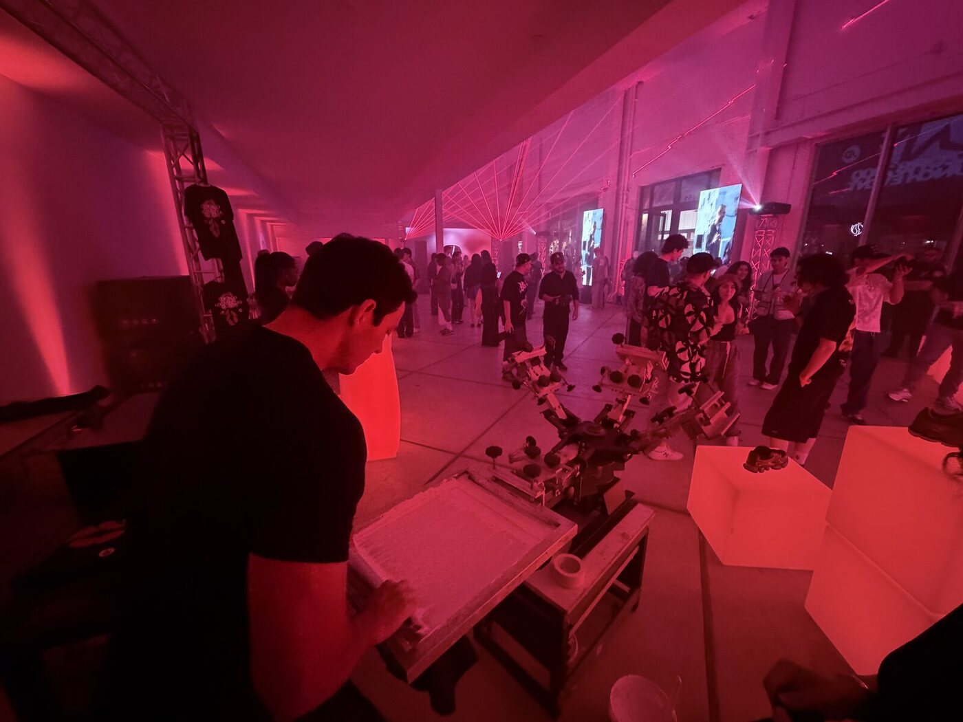 A crowd gathered around a Merch Troop live printing activation at a Chicago event